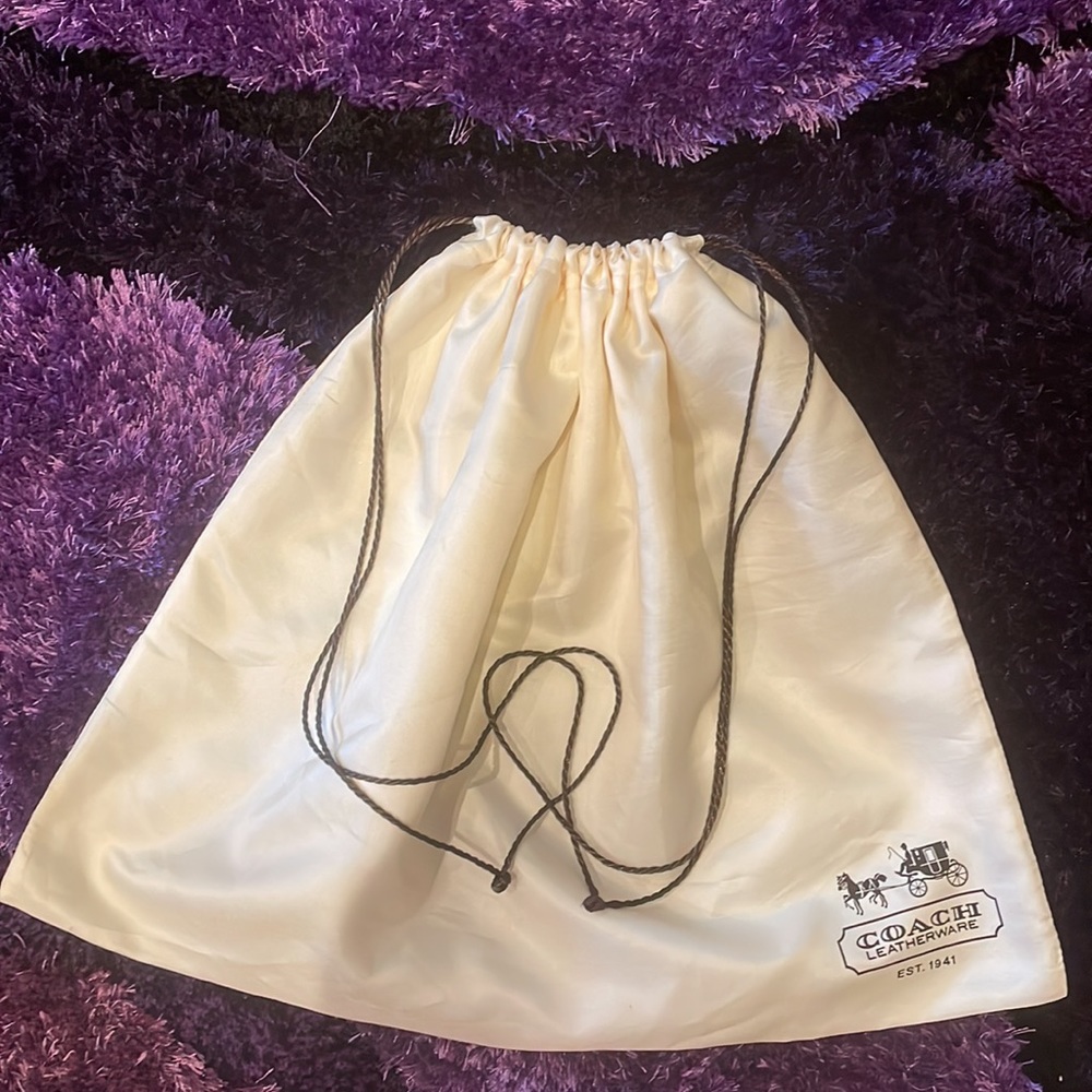 White satin Coach drawstring dust bag. Size is 19” wide by 15” long.